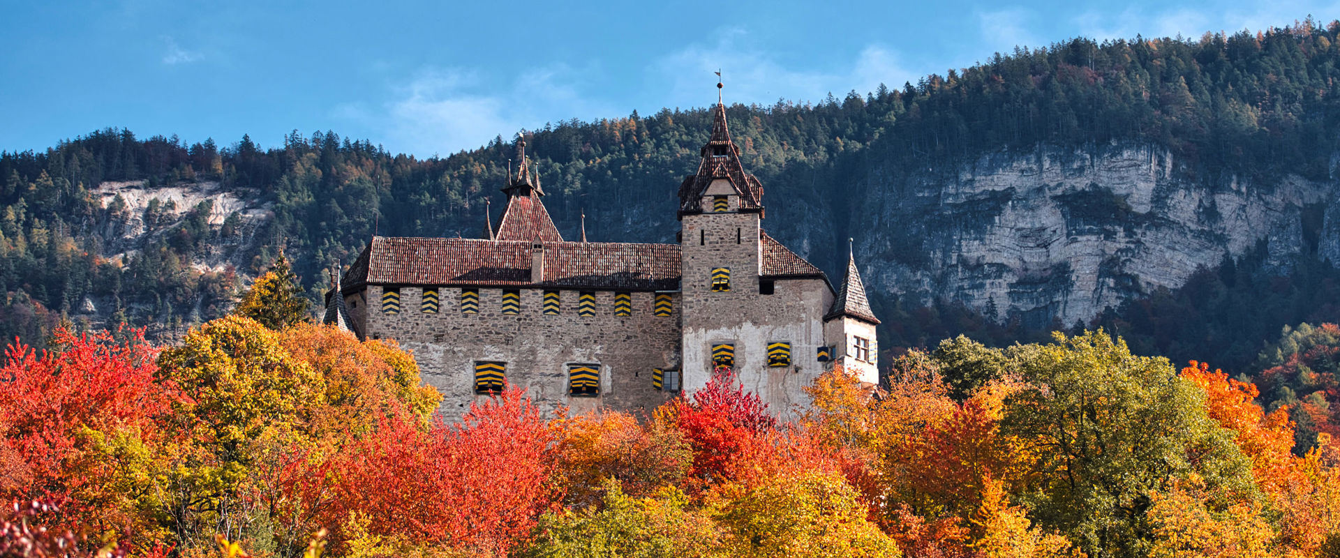 Enn Castle in autumn View of Enn Castle nestled in an autumnal landscape with colourful trees.