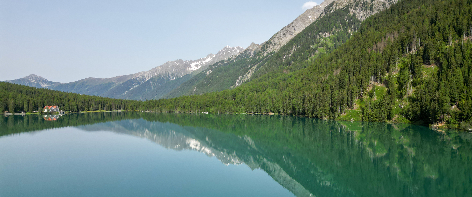Lake Antholz in summer Green-blue mountain lake (Lake Antholz) surrounded by dense forest