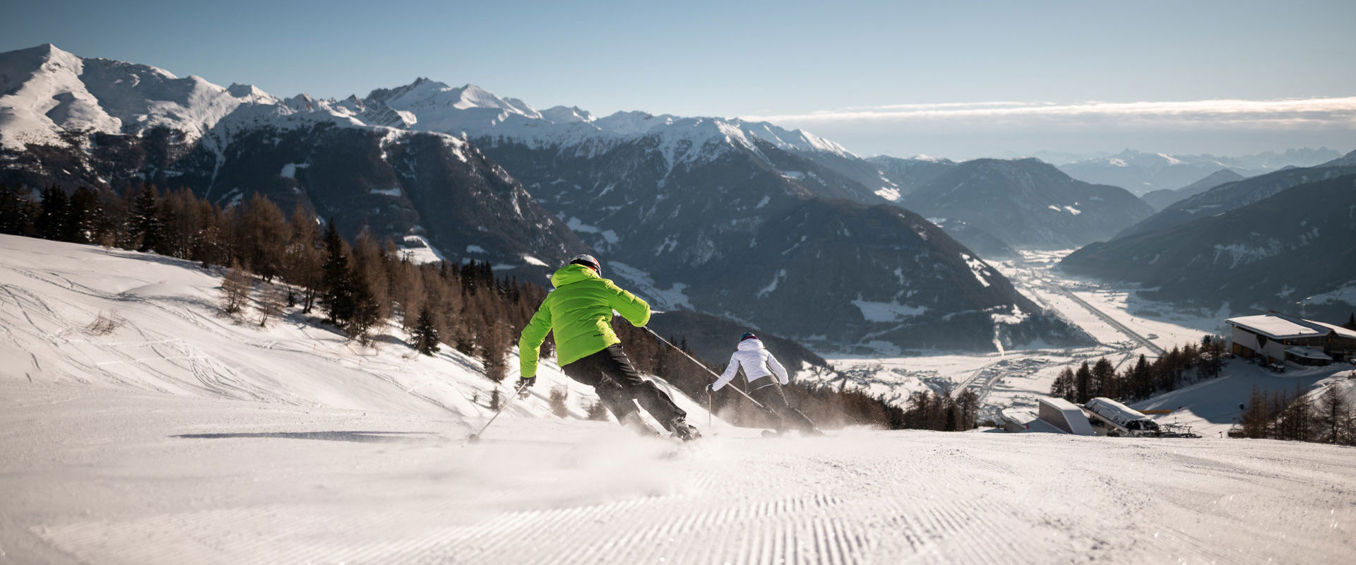 Ski area Rosskopf 2 skiers ride down the freshly groomed slope.